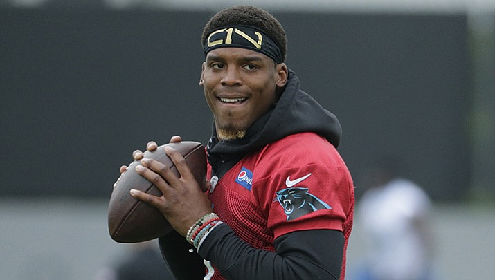 In this May 30, 2017, file photo, Carolina Panthers' Cam Newton runs a drill during an NFL football practice in Charlotte, N.C. Panthers coach Ron Rivera says quarterback Cam Newton is ahead of schedule in his rehab from shoulder surgery and is expected to begin throwing next week at minicamp.