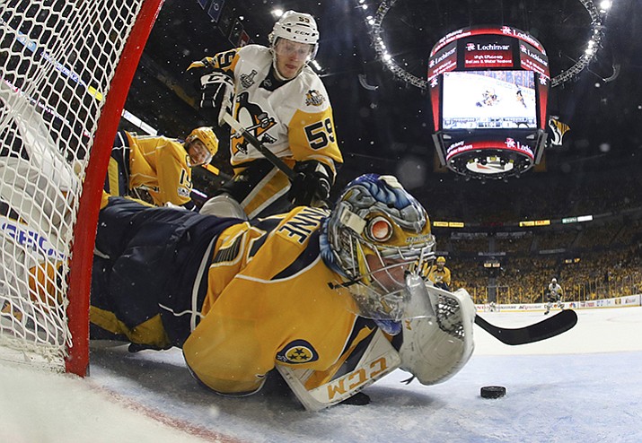 Nashville Predators goalie Pekka Rinne (35) stops a shot by Pittsburgh Penguins center Jake Guentzel (59) during the second period in Game 4 of the NHL hockey Stanley Cup Final Monday, June 5, in Nashville, Tenn.