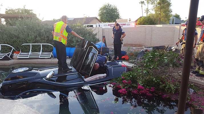 Fire and police first responders rescued an elderly man from an SUV before it became fully submerged underwater on its side in a pool in Scottsdale Monday. (Scottsdale Fire Department photo)