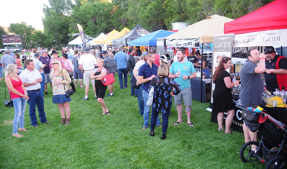 Crowds gather at the inaugural Arizona Craft Distillers Guild Festival and Balloon Glow Friday, June 9 on the football field at Prescott Mile High Middle School.  (Les Stukenberg/Courier)