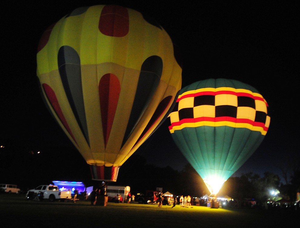 Finally after the winds became more consistent the ballonists start the inflation process at the inaugural Arizona Craft Distillers Guild Festival and Balloon Glow Friday, June 9 on the football field at Prescott Mile High Middle School.  (Les Stukenberg/Courier)