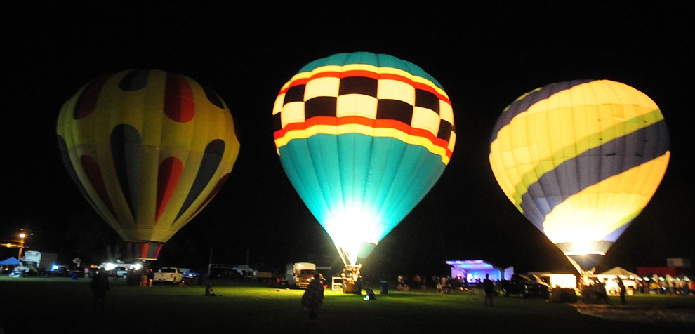 Three of the balloons are inflated at the inaugural Arizona Craft Distillers Guild Festival and Balloon Glow Friday, June 9 on the football field at Prescott Mile High Middle School.  (Les Stukenberg/Courier)