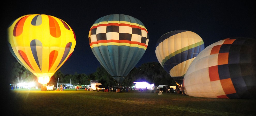 Three of the balloons are inflated at the inaugural Arizona Craft Distillers Guild Festival and Balloon Glow Friday, June 9 on the football field at Prescott Mile High Middle School.  (Les Stukenberg/Courier)