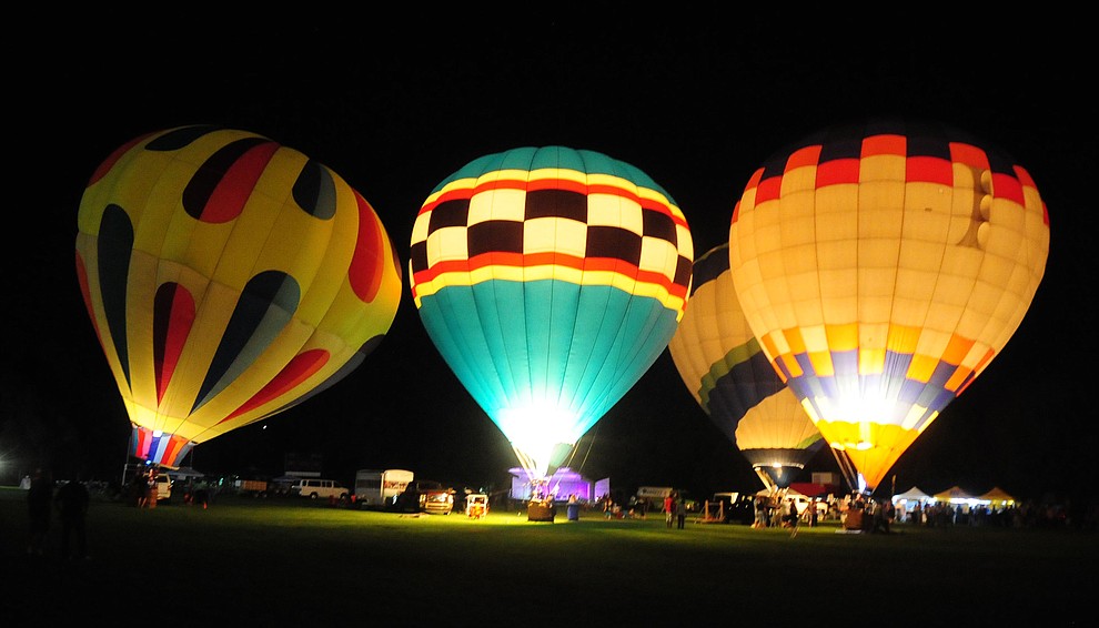 With four balloons inflated the party continues at the inaugural Arizona Craft Distillers Guild Festival and Balloon Glow Friday, June 9 on the football field at Prescott Mile High Middle School.  (Les Stukenberg/Courier)