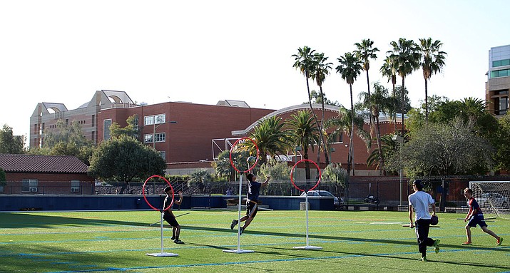 University of Arizona Quidditch team members practice their best shots on the enemy hoops. (Photo by: Haley Ford/Arizona Sonora News Service)