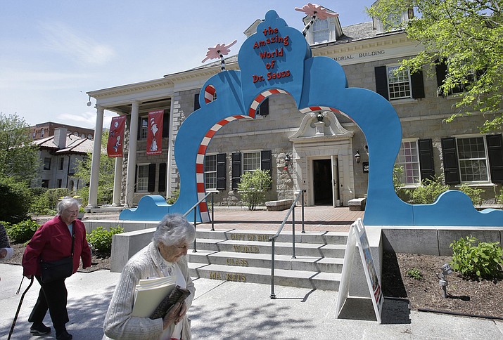 People walk near an entrance to The Amazing World of Dr. Seuss Museum, in Springfield, Mass. The new museum devoted to Dr. Seuss, which opened on June 3 in his hometown, features interactive exhibits, a collection of personal belongings and explains how the childhood experiences of the man, whose real name is Theodor Geisel, shaped his work. (AP Photo/Steven Senne)

