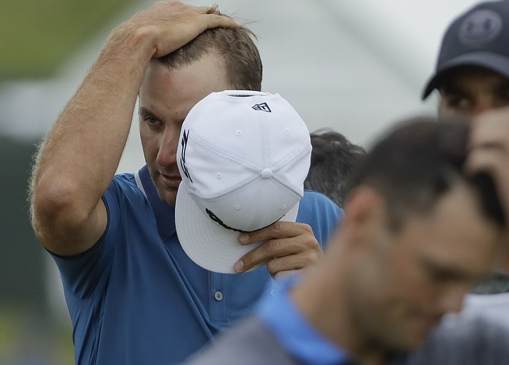 Dustin Johnson wipes his head as he walks off the 18th green during the second round of the U.S. Open on Friday, June 16, 2017, at Erin Hills in Erin, Wis. (David J. Phillip/AP)