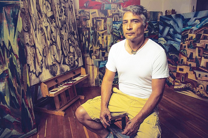 Tony Abeyta surrounded by his work, some of which is on display at Museum of Northern Arizona through Sept. 4. Submitted photo