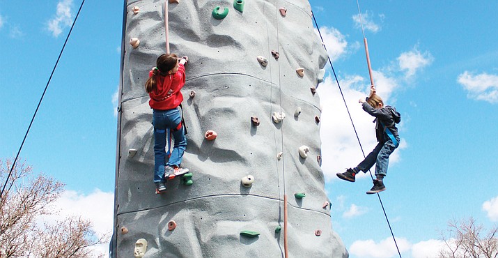 Visitors enjoy the new climbing wall at Rockin' the Wall on Route 66. 