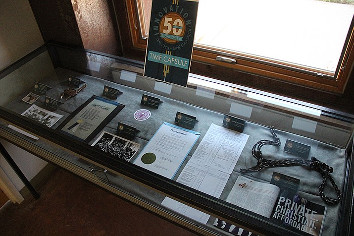 Various items being considered to go inside Prescott College’s 50th anniversary time capsule are on display at the college’s library until the end of June. 