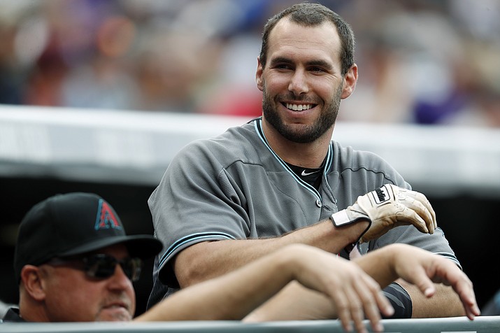 Paul Goldschmidt, right, jokes with pitching coach Mike Butcher as he waits to bat Thursday, June 22, 2017, in Denver. (David Zalubowski/AP)