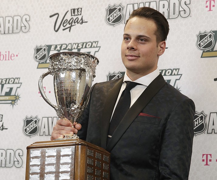 Auston Matthews of the Toronto Maple Leafs and former Scottsdale prep star holds the Calder Memorial Trophy, which awards the top rookie, after winning the award during the NHL Awards, Wednesday, June 21, 2017, in Las Vegas. (John Locher/AP)