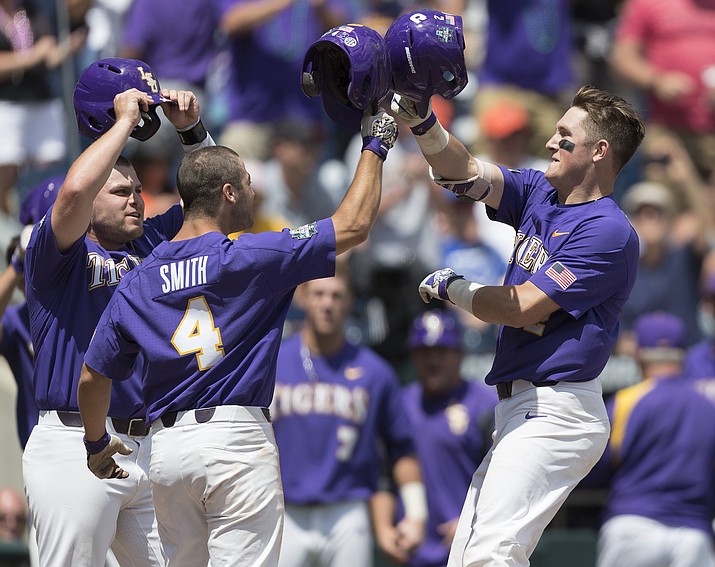 LSU’s Michael Papierski, right, is greeted by Josh Smith (4) and Beau Jordan after hitting a three-run home run against Oregon State during a College World Series baseball game Saturday, June 24, 2017, in Omaha, Neb. (Ryan Soderlin/Omaha World-Herald via AP)