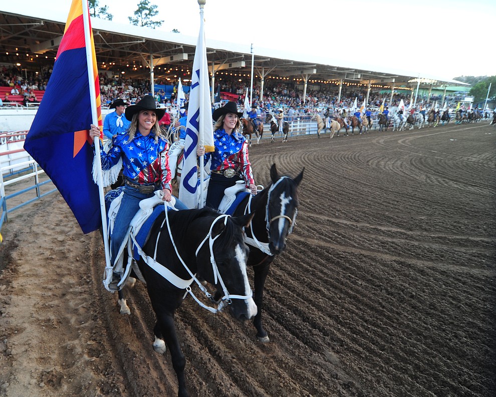 The grand entry makes its way around the arena during the opening performance of the Prescott Frontier Days Rodeo Wednesday, June 28 at the Prescott Rodeo Grounds.  (Les Stukenberg/Courier)