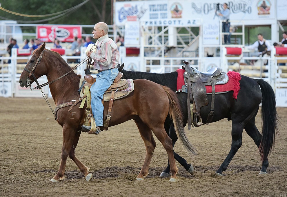JC Trujillo leads a riderless horse as a tribute for Harry Vold during the opening performance of the Prescott Frontier Days Rodeo Wednesday, June 28 at the Prescott Rodeo Grounds.  (Les Stukenberg/Courier)