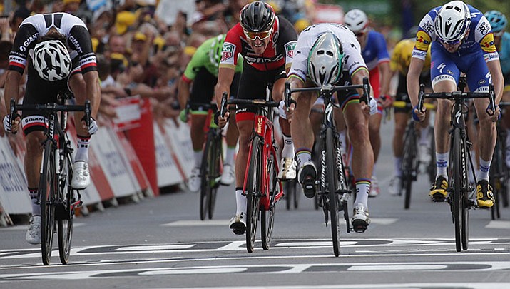 Peter Sagan of Slovakia, second right, pushes his bicycle over the finish line ahead of second place Australia’s Michael Matthews, left, third place Ireland’s Daniel Martin, right, and Belgium’s Greg van Avermaet, second left, to win the third stage of the Tour de France cycling race over 132 miles with start in Verviers, Belgium and finish in Longwy, France, Monday, July 3.
