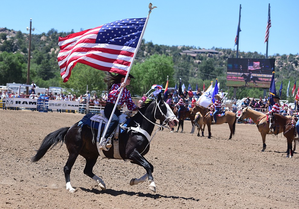 Running in the American flag during the 8th and final performance of the Prescott Frontier Days Rodeo Tuesday, July 4 at the Prescott Rodeo Grounds.  (Les Stukenberg/Courier)