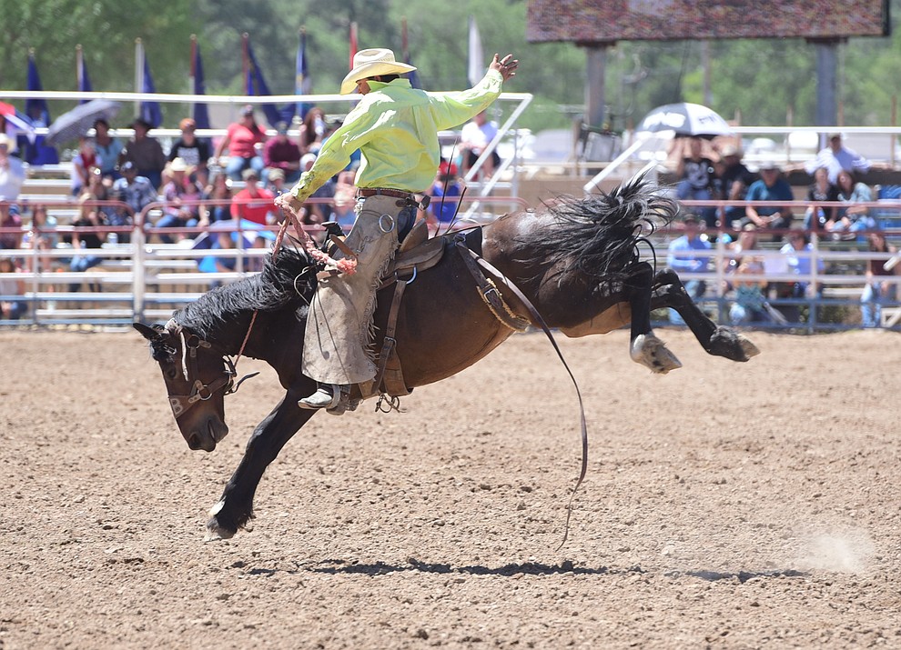 Brett Behrends rides in the Cowpuncher's Ranch Bronc Riding during the 8th and final performance of the Prescott Frontier Days Rodeo Tuesday, July 4 at the Prescott Rodeo Grounds.  (Les Stukenberg/Courier)