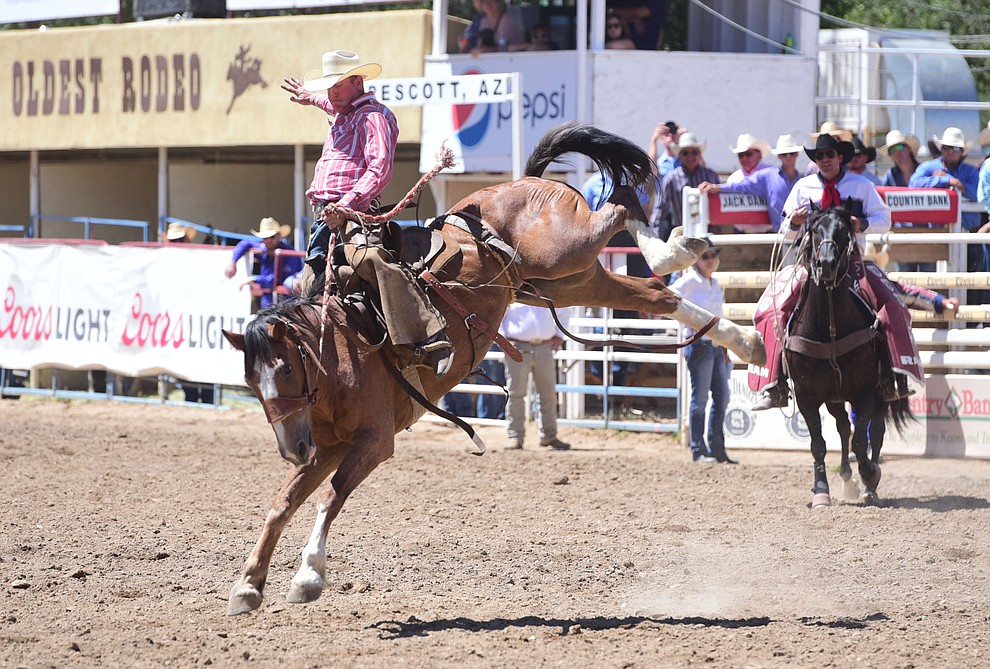 Michael Brockett rides in the Cowpuncher's Ranch Bronc Riding during the 8th and final performance of the Prescott Frontier Days Rodeo Tuesday, July 4 at the Prescott Rodeo Grounds.  (Les Stukenberg/Courier)