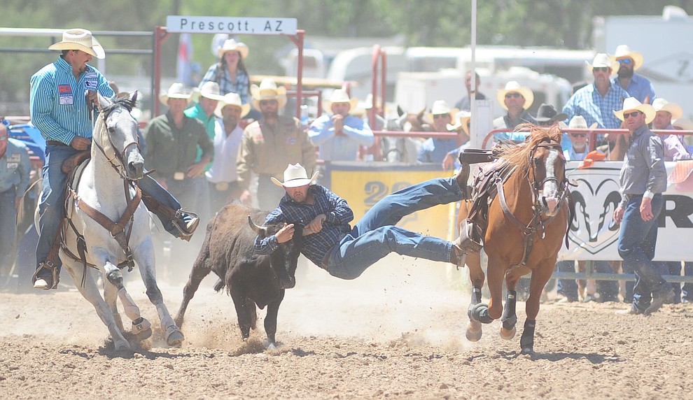 Blaine Jones runs 5.1 seconds in the steer wrestling during the 8th and final performance of the Prescott Frontier Days Rodeo Tuesday, July 4 at the Prescott Rodeo Grounds.  (Les Stukenberg/Courier)