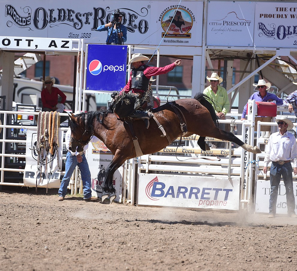 Lefty Holman rides Sun Glow for a score of 78 in the saddle bronc during the 8th and final performance of the Prescott Frontier Days Rodeo Tuesday, July 4 at the Prescott Rodeo Grounds.  (Les Stukenberg/Courier)
