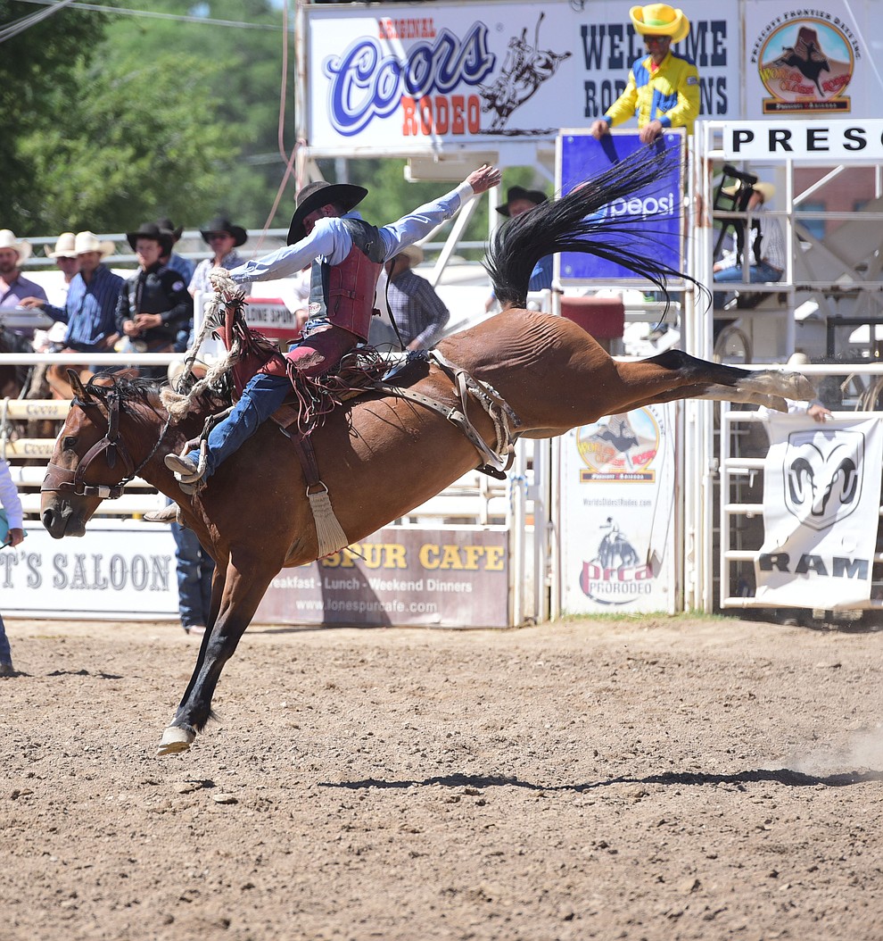 Telden McClain rides Music Man in the saddle bronc during the 8th and final performance of the Prescott Frontier Days Rodeo Tuesday, July 4 at the Prescott Rodeo Grounds.  (Les Stukenberg/Courier)