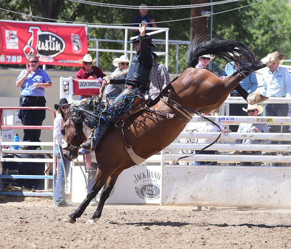 Zeke Thurston rides Ropin Dreams for a score of 86 in the saddle bronc during the 8th and final performance of the Prescott Frontier Days Rodeo Tuesday, July 4 at the Prescott Rodeo Grounds.  (Les Stukenberg/Courier)