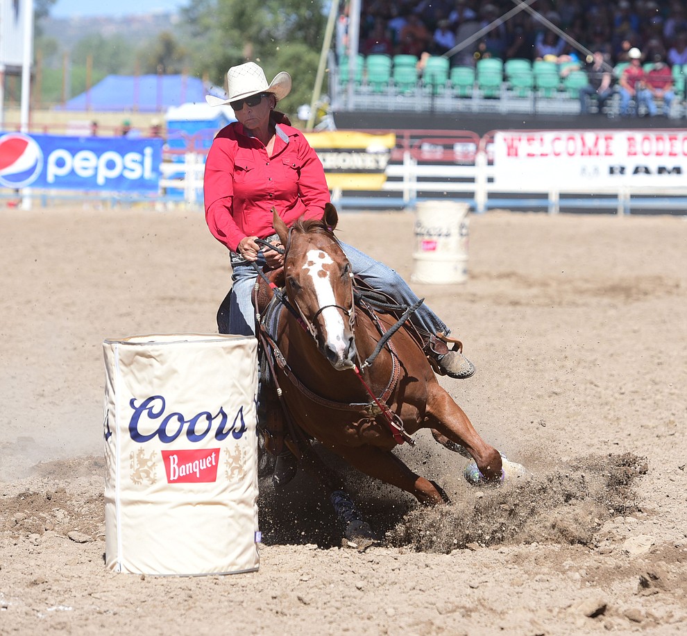 Deb Smith runs a 19.5 in the barrel race during the 8th and final performance of the Prescott Frontier Days Rodeo Tuesday, July 4 at the Prescott Rodeo Grounds.  (Les Stukenberg/Courier)