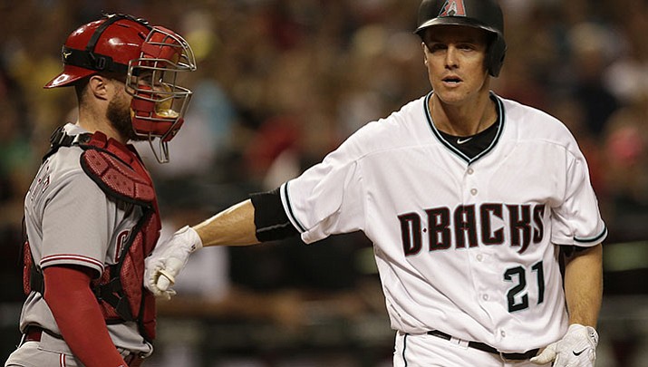 Arizona Diamondbacks Zack Greinke (21) reacts with Cincinnati Reds catcher Tucker Barnhart after getting hit by a pitch in the second inning during a baseball game, Friday, July 7, in Phoenix. 