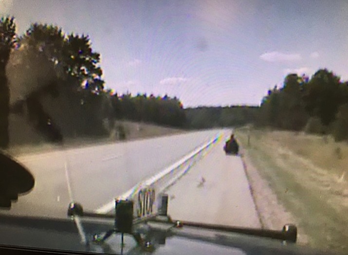 This photo shows a 76-year-old woman driving a mobility scooter down the shoulder of Interstate 75 in Michigan. (Michigan State Police photo)
