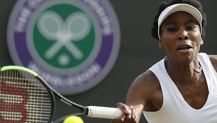 Venus Williams of the United States returns to Japan's Naomi Osaka during their Women's Singles Match on day five at the Wimbledon Tennis Championships in London Friday, July 7.