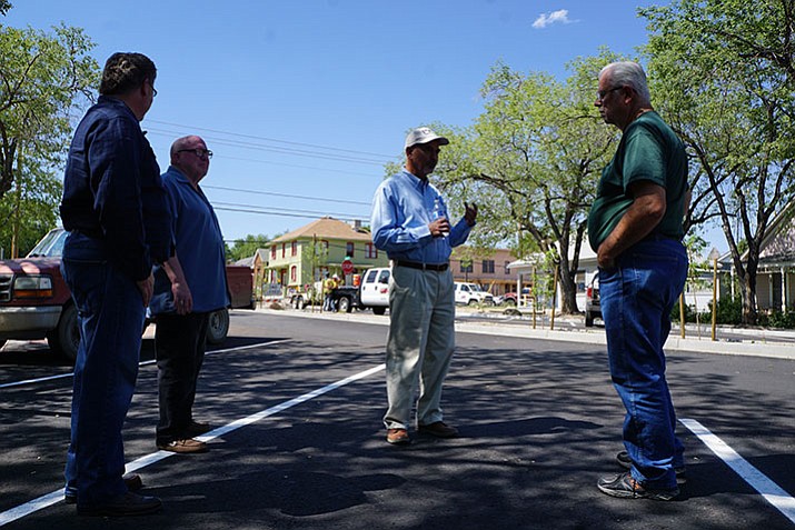 Prescott Public Works Director Henry Hash, second from right, talks about the Alarcon Street reconstruction project with, from left, City Engineer Charles Andrews, and Alarcon residents Don Miller and Dave Arave. The downtown-Prescott project, which earlier faced delays due to wet winter weather and unexpected underground conditions, is wrapping up this month. Paving was applied the week before July 4, and workers were doing finishing touches this week.
