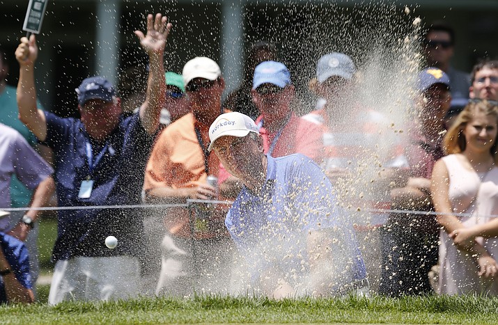 Davis Love III, center, hits out of a bunker on the first hole during the final round of the Greenbrier Classic PGA Tour golf tournament Sunday, July 9, , in White Sulphur Springs, W.Va. (Steve Helber/AP)