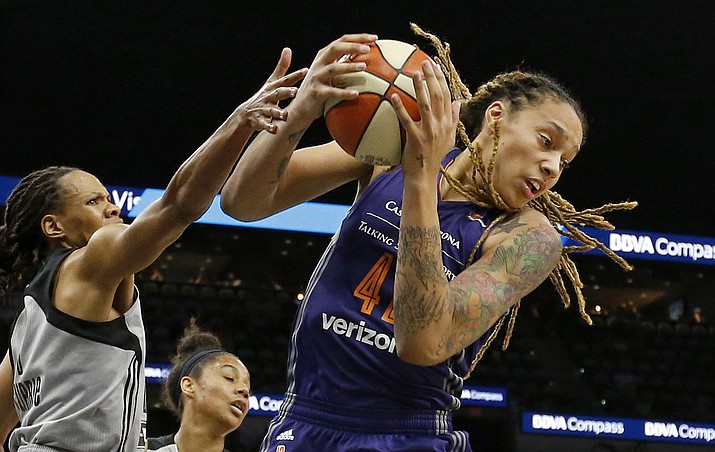 In this May 19, 2017, file photo, San Antonio Stars' Monique Currie, left, and Phoenix Mercury's Brittney Griner, right, grab for a rebound during the first-half in San Antonio. (Edward A. Ornelas/AP, File)