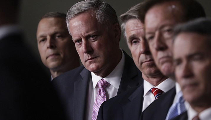 House Freedom Caucus Chairman Rep. Mark Meadows, R-N.C., second from left, and others, participates in a news conference on Capitol Hill in Washington, Wednesday, July 12, 2017, to say that his group wants to delay the traditional August recess until work is accomplished on health care, the debt ceiling and tax reform. 
