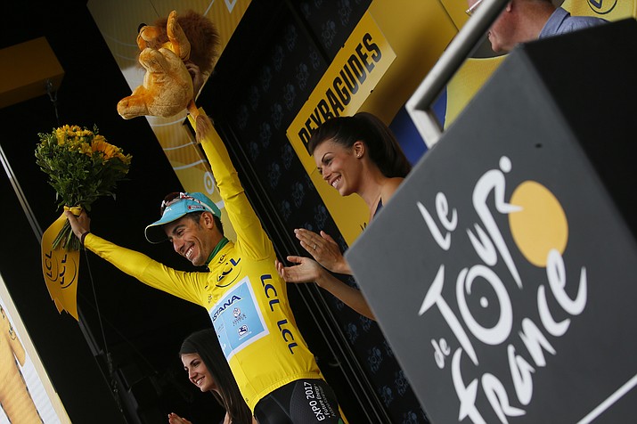 Italy's Fabio Aru, wearing the overall leader's yellow jersey, celebrates on the podium after the 12th stage of the Tour de France cycling over 133.3 miles with start in Pau and finish in Peyragudes, France, Thursday, July 13, 2017. (Peter Dejong/AP)
