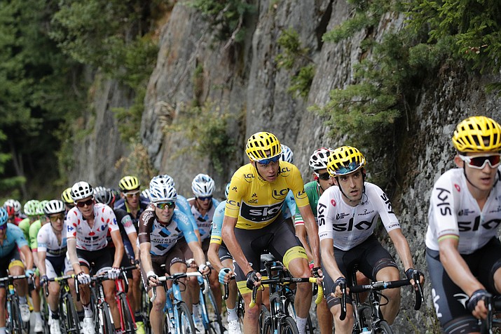 Britain’s Chris Froome, wearing the yellow jersey, and Italy’s Fabio Aru, in tricolor jersey, race on Wednesday in Serre-Chevalier, France. (Christophe Ena/AP)