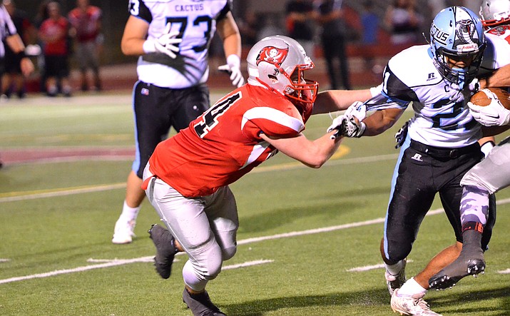 Mingus Union linebacker Kendrew Streck drags down a Cactus runner by his undershirt last year. The Marauders beat the Cobras 35-28 and face them Sept. 8 on the road this season. (VVN/Vyto Starinskas)