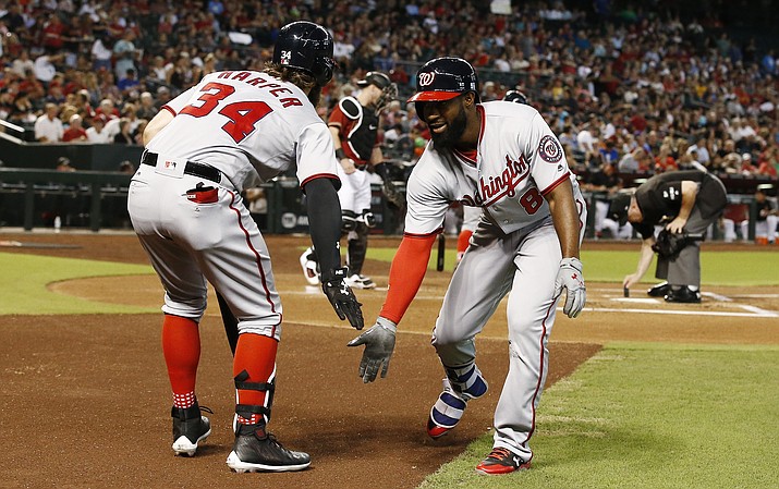 Washington’s Brian Goodwin (8) celebrates his home run against the Diamondbacks with Bryce Harper (34) during the first inning of a baseball game Sunday, July 23, in Phoenix. (Ross D. Franklin/AP)