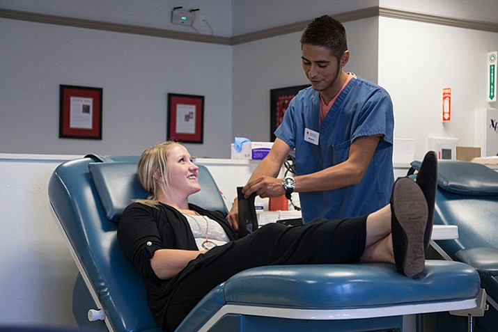 23-year-old Kelsie Webster chats with Red Cross staffer Alberto Duenas while donating blood for the first time. (Amanda Romney/American Red Cross) 

