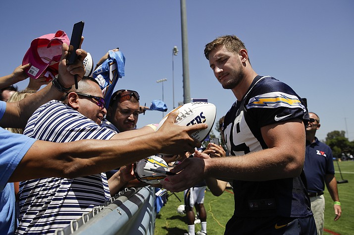 Los Angeles Chargers defensive end Joey Bosa, right, gives autographs at NFL football training camp Sunday. (Jae C. Hong/AP)