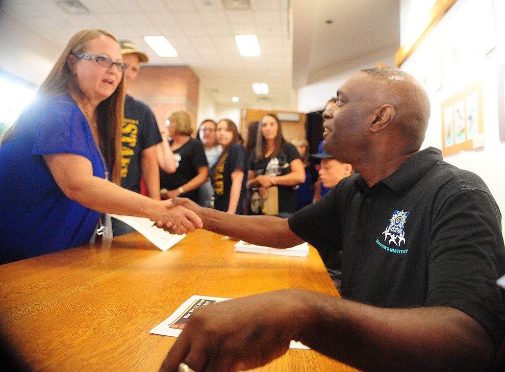 Antwone Fisher, American screenwriter, poet, lecturer and best-selling author greets teachers following the 2017/18 school Prescott Unified School District Convocation Monday, July 31 at Prescott High School. (Les Stukenberg/Courier)