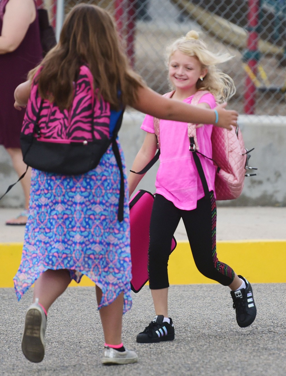 Mackenzie Cheney runs to greet Adrienne Heffner at Lincoln School as students began the 2017-18 school year Thursday, August 2 in Prescott. (Les Stukenberg/Courier)