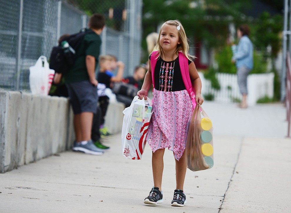 Emma Sarner arrives with her hands full at Lincoln School as students began the 2017-18 school year Thursday, August 2 in Prescott. (Les Stukenberg/Courier)