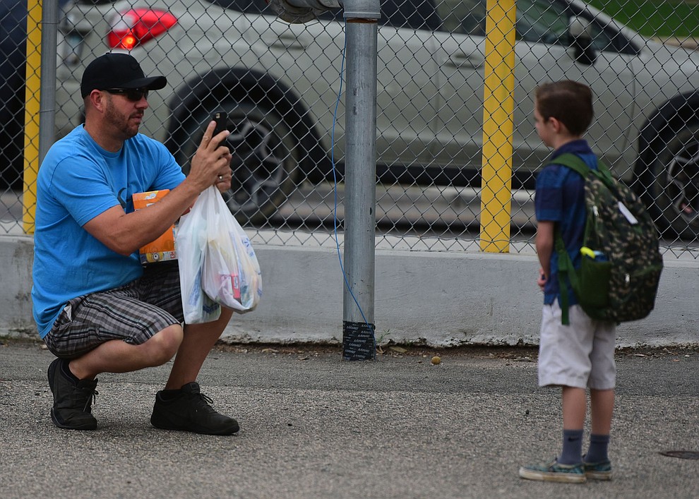 Doug Reed takes a photo of his nephew Lane Odom at Lincoln School as students began the 2017-18 school year Thursday, August 2 in Prescott. (Les Stukenberg/Courier)