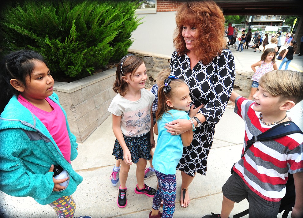 Students give Principal Karen Hughes a hug at Lincoln School as students began the 2017-18 school year Thursday, August 2 in Prescott. (Les Stukenberg/Courier)