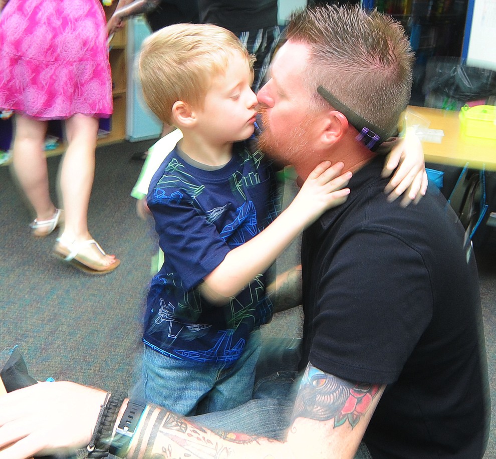 Kindergartner Gavin Luhmann gives his dad a kiss at Lincoln School as students began the 2017-18 school year Thursday, August 2 in Prescott. (Les Stukenberg/Courier)