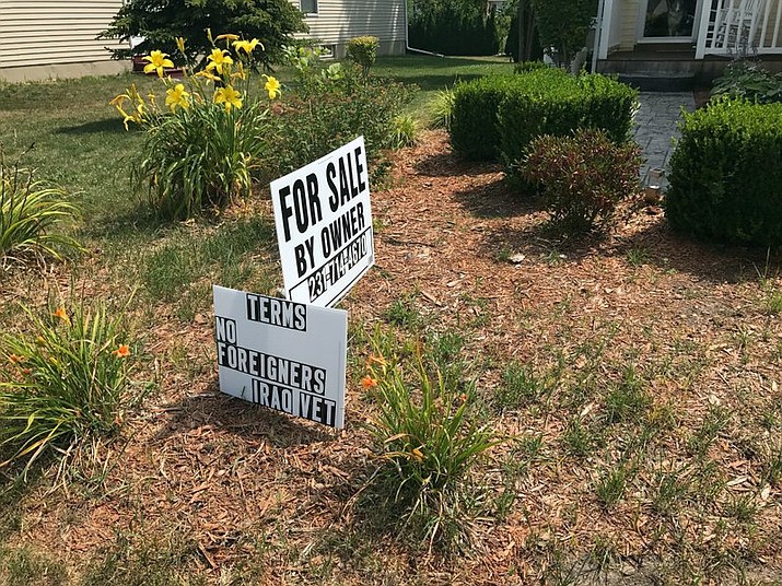 This photo taken Aug. 2, 2017, shows the “No Foreigners” sign in front of James Prater’s home in Mason, Mich. Prater of Mason says he has the right to sell his house to the person of his choosing. Michigan Department of Civil Rights officials say a veteran’s front-yard sign advertising the sale of his home violates state and federal laws because it calls for “no foreigners.” (Judy Putnam /Lansing State Journal via AP)