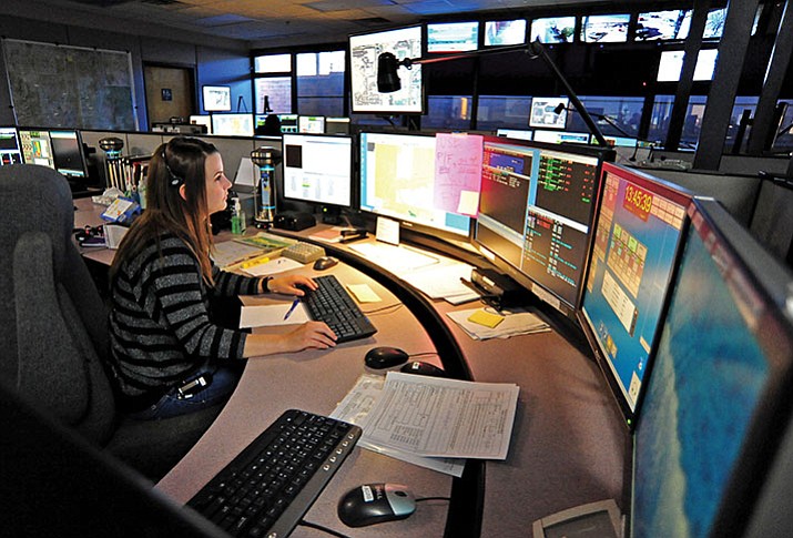 Megan Neighbors, a communication specialist, answers a 911 call at the Prescott Regional Communication Center. (File Photo)