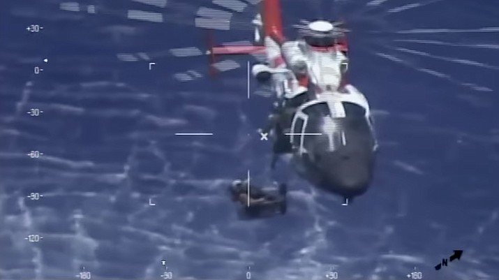 A Coast Guard helicopter assists in the rescue of a Navy jet pilot in the water 20 miles southeast of Key West Wednesday. (U.S. Coast Guard)